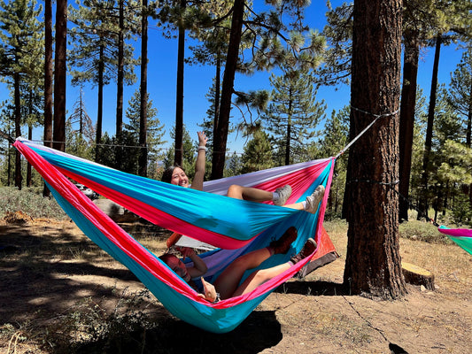 Friends hanging out in ThirdWheeler bunk bed hammock in forest