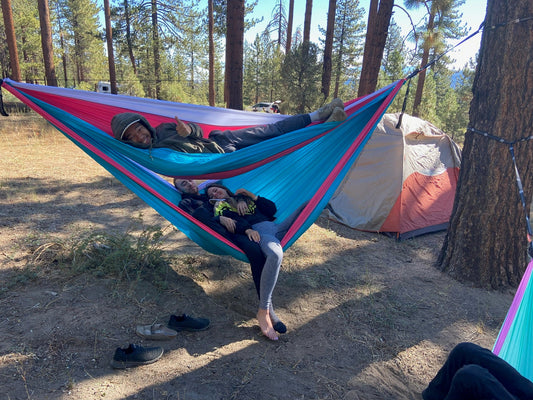 Group of friends in ThirdWheeler hammock at campsite